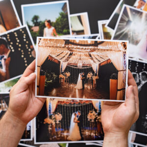 Hands,Lay,Out,A,Printed,Copy,Of,The,Wedding,Photos.